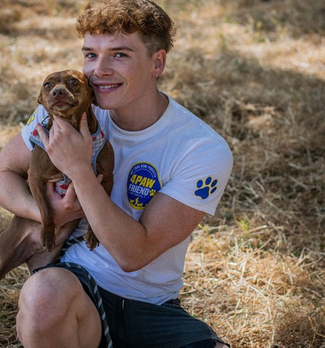 Austin, dog walker at 4 Paw Friend, with a dog in his care in South London.