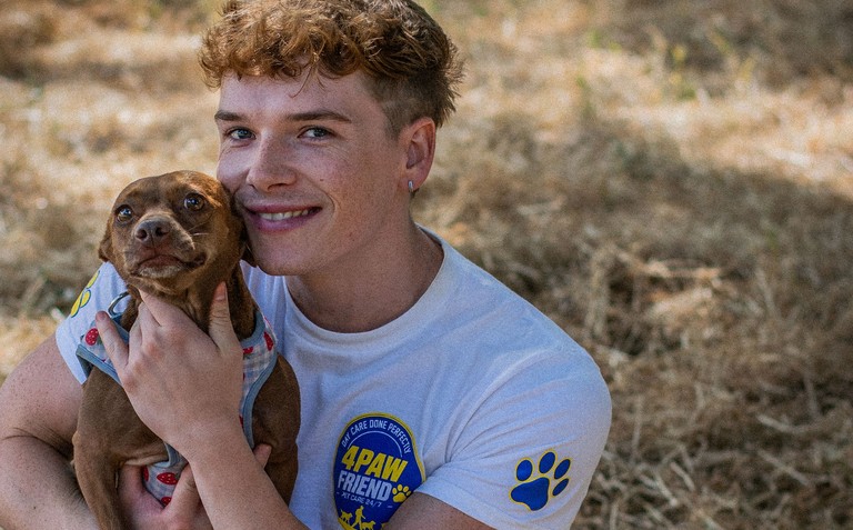 Austin, dog walker at 4 Paw Friend, with a dog in his care in South London.